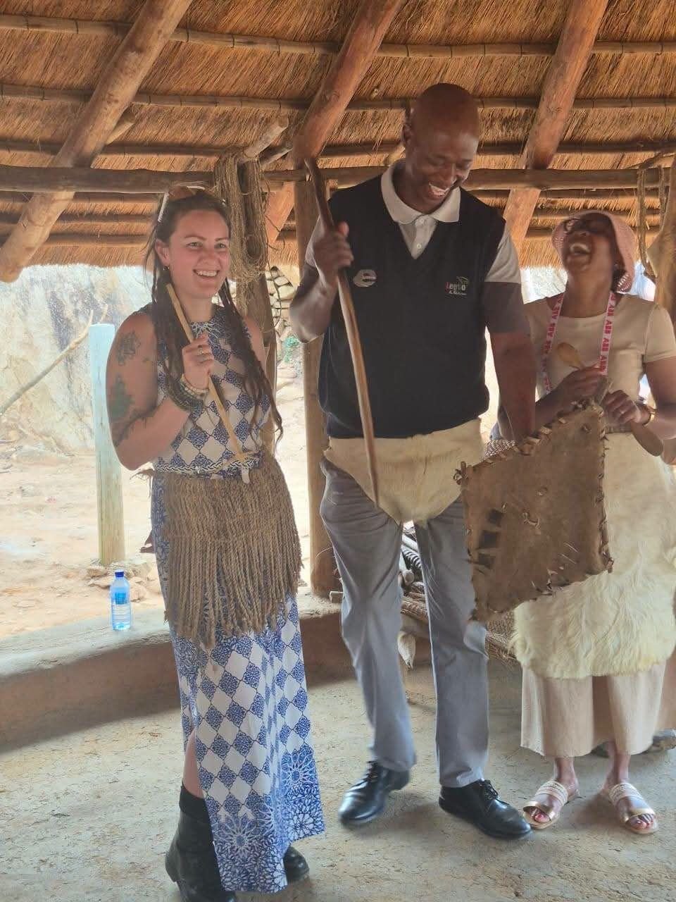 A guide with guests in traditional dress at Bakone Malapa, Limpopo