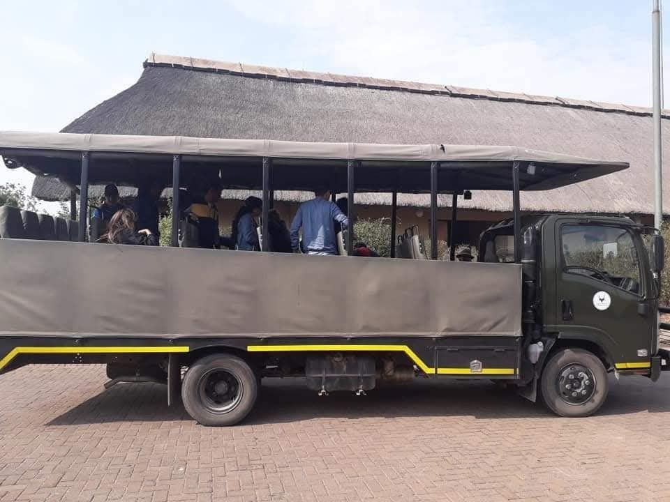 Guests aboard a Malala-Tau open game viewer at a safari lodge