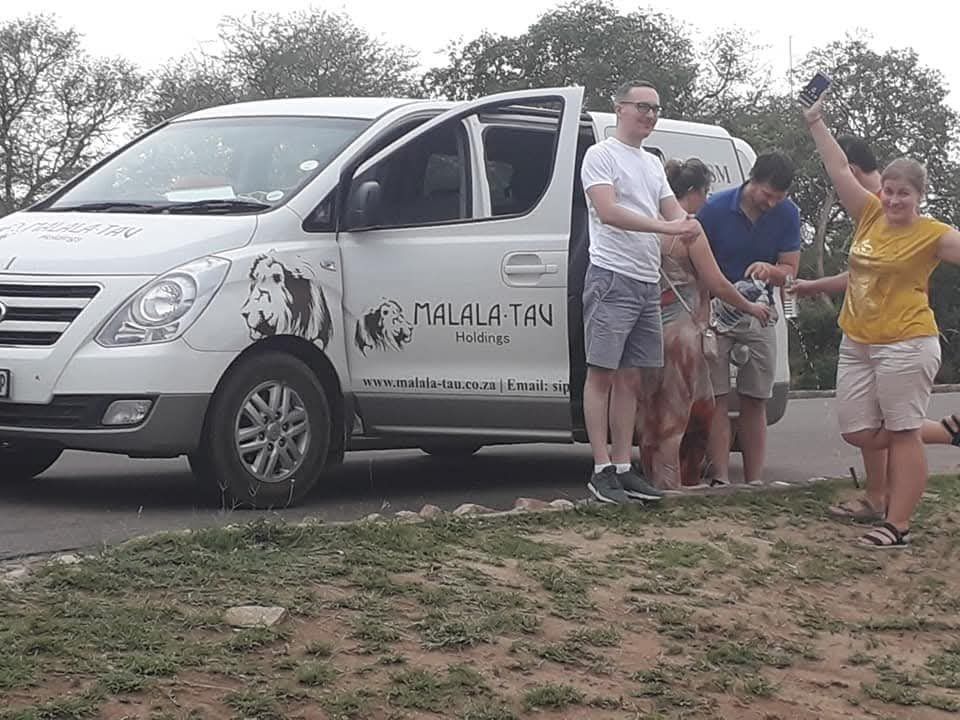International travellers with their Malala-Tau guide and shuttle in South Africa