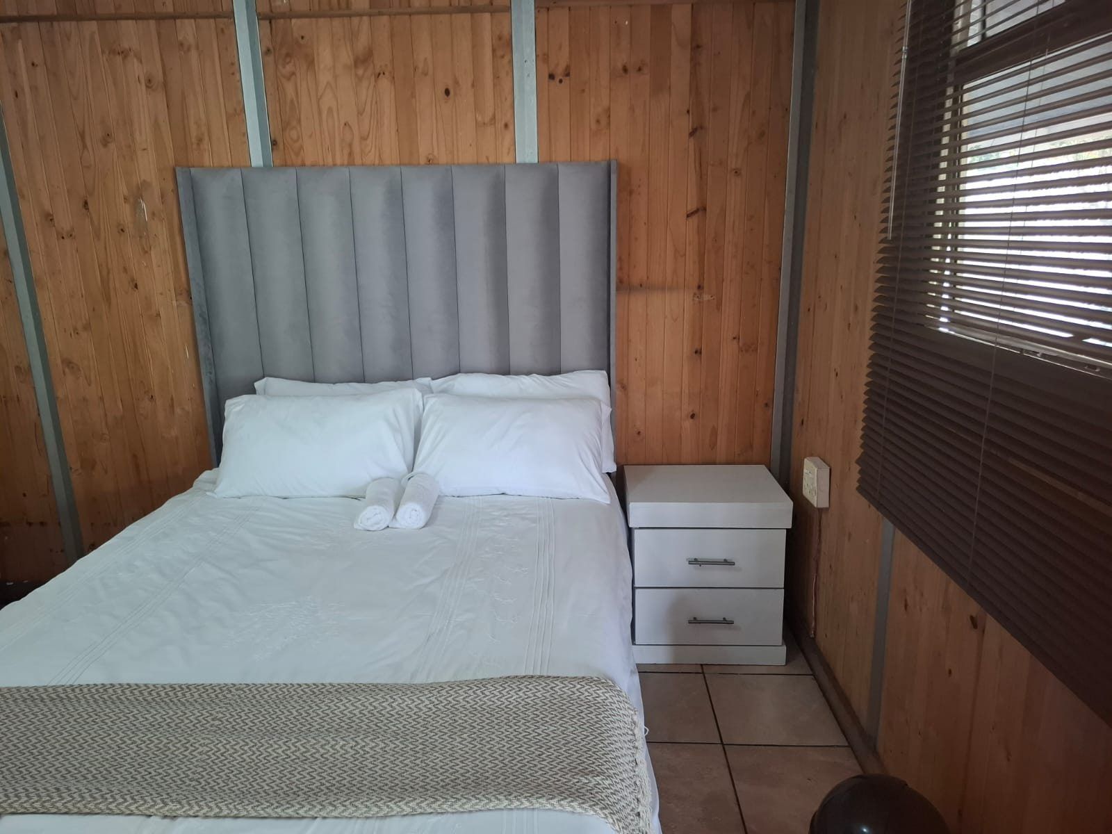 Wood-panelled ensuite room at Ubuntu Kraal Backpackers