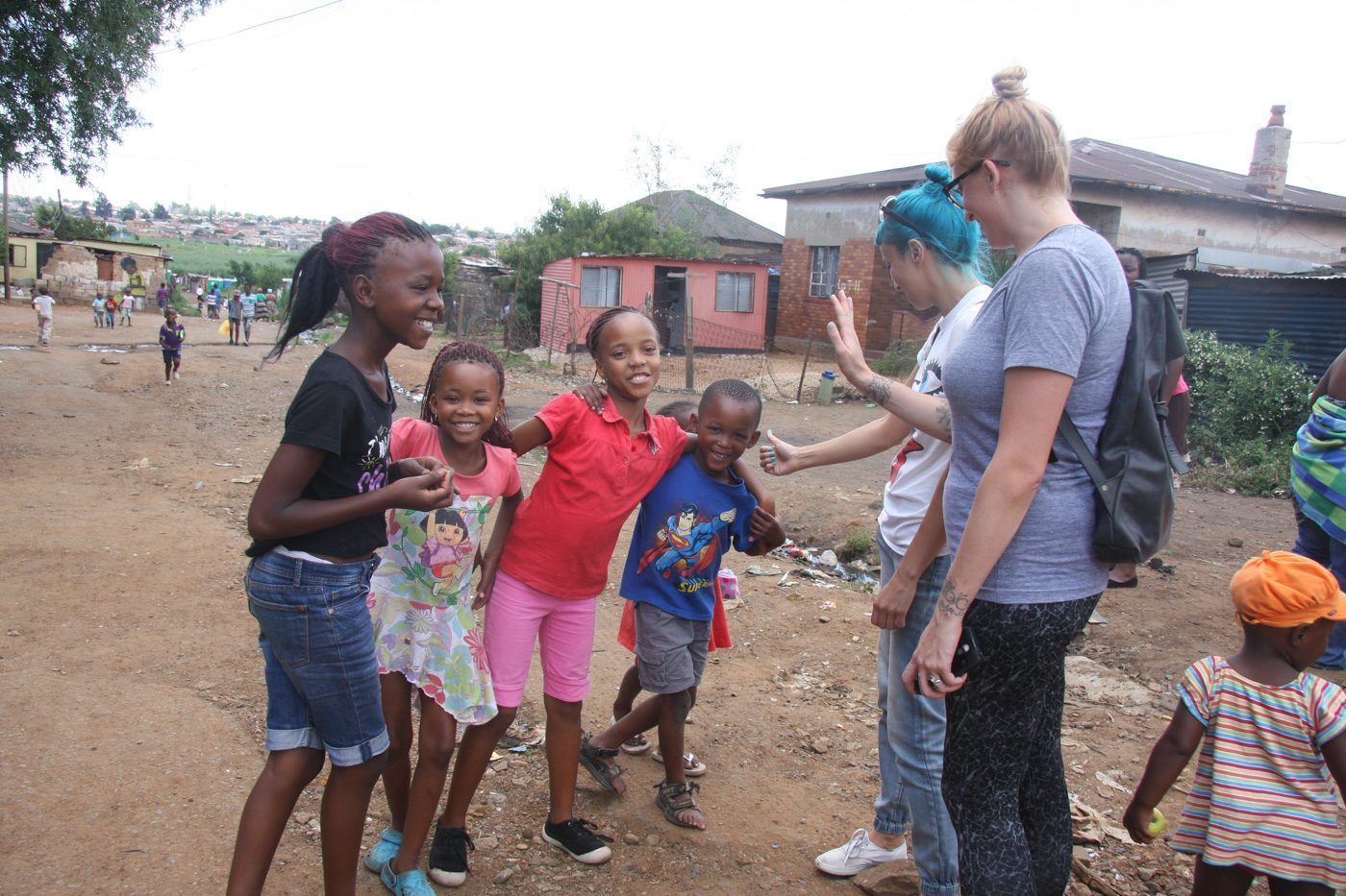 A Malala-Tau guest meeting children on a Soweto community tour